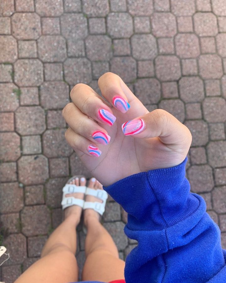 Nails with pink, blue and lilac swirl designs