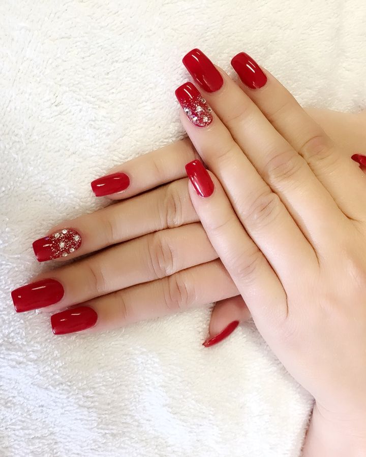 Glossy red square nails with a rhinestone accent nail